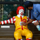 A worker cleans Ronald McDonald for the reopening of the outlet after it was shut down as a precaution against COVID-19.